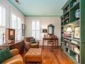 Cozy living room boasts hardwood floors, a teal ceiling, and built-in shelving showcasing collectibles at 206 White Gables Dr, Summerville, SC 29483