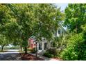 Inviting two-story home with a covered porch, set back from the street with lush landscaping at 220 Ponsbury Rd, Mount Pleasant, SC 29464