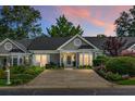 Charming single-story home with inviting curb appeal enhanced by colorful twilight skies at 2438 Hansard Dr, North Charleston, SC 29406