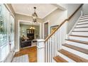 Inviting entryway with hardwood floors, staircase, and a view of the living room through an arched doorway at 2800 River Vista Way, Mount Pleasant, SC 29466