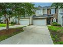 Inviting townhomes featuring attached garages and well-maintained driveways, blending convenience with classic appeal at 3012 Candela Grove Dr, Charleston, SC 29414