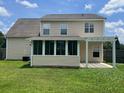 Backyard view showcasing a covered patio, screened in porch, and green lawn at 412 Beverly Dr, Summerville, SC 29485
