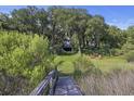 Scenic backyard with mature trees, and inviting seating area, providing a tranquil retreat at 4601 Apple St, North Charleston, SC 29405