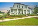 Attractive two-story home with a welcoming front porch, well-manicured lawn, and inviting curb appeal at 501 Rhythm St, Summerville, SC 29486
