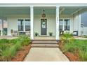 Inviting front porch with comfortable seating, decorative wreath, and stylish outdoor decor at 501 Rhythm St, Summerville, SC 29486