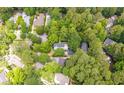 An aerial shot displays the home's location within a verdant, residential neighborhood, enveloped by mature trees at 5152 Coral Reef Dr, Johns Island, SC 29455