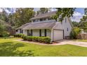 Two-story home featuring well-maintained lawn, attached garage, and a welcoming facade at 600 Dolphin Dr, Summerville, SC 29485