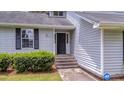 Close-up of a home's front entrance featuring steps leading up to a dark-colored door, number 600 at 600 Dolphin Dr, Summerville, SC 29485