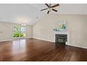 Open-concept living room with vaulted ceilings, hardwood floors, and cozy fireplace at 633 Alwyn Blvd, Summerville, SC 29485