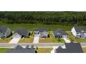 A beautiful aerial view of the property, showcasing the home's placement near a lake and lush greenery at 7011 Pumpkinseed Dr, Johns Island, SC 29455