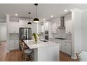Modern kitchen with stainless steel appliances, a large island, and pristine white cabinetry at 7011 Pumpkinseed Dr, Johns Island, SC 29455