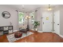 Inviting entryway with hardwood floors, a cozy chair, and stylish decor at 7030 Billberry St, Hanahan, SC 29410