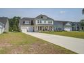 Charming two-story home boasts a two-car garage, long driveway, and inviting front porch at 7035 Pumpkinseed Dr, Johns Island, SC 29455