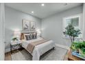 Cozy bedroom with a comfortable bed, natural light, and stylish decor at 7631 Indigo Palms Way, Johns Island, SC 29455