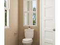 Cozy powder room featuring a toilet with white fixtures and a small window for natural light at 786 Ridgley Dr, Summerville, SC 29486