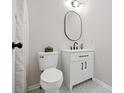 Modern bathroom with white vanity, oval mirror, and patterned tile flooring at 8112 Halifax Way, North Charleston, SC 29420