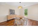 Bright dining room with hardwood floors, modern light fixture, and stylish furniture at 8112 Halifax Way, North Charleston, SC 29420