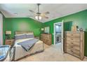 Spacious bedroom with hardwood furniture, ceiling fan, and an ensuite bathroom offering comfort and functionality at 9101 Parlor Dr, Ladson, SC 29456