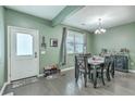 Cozy dining area featuring wood floors, a table with six chairs and a modern chandelier providing ample lighting at 9101 Parlor Dr, Ladson, SC 29456