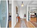 Welcoming foyer with hardwood floors, neutral walls, decorative rug, and elegant lighting fixture at 9133 Markleys Grove Blvd, Summerville, SC 29485