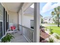 Charming porch with a rocking chair, side table, and beautiful views of the neighborhood at 9133 Markleys Grove Blvd, Summerville, SC 29485