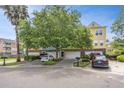 Street view of colorful townhomes with garages and beautiful mature landscaping at 9305 Sweetbay Ct, Ladson, SC 29456