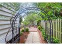 A backyard scene features a metal archway leading to an outdoor seating area at 1025 Mathis Ferry Rd, Mount Pleasant, SC 29464