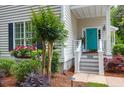 Close up of home's entrance featuring a vibrant turquoise door and manicured landscaping at 1025 Mathis Ferry Rd, Mount Pleasant, SC 29464