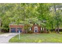 Inviting brick home with a well-maintained lawn and charming front entrance at 103 Sylvan Ter, Summerville, SC 29485