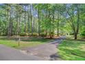 The driveway winds through a beautiful property with mature trees and landscaping at 107 Kimberwicke Dr, Summerville, SC 29483