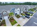 Aerial view of colorful townhomes with driveway parking, landscaping, and neighborhood street at 108 Rosefield Ct, Summerville, SC 29485