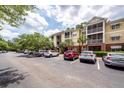 Apartment building featuring a well-maintained parking lot, yellow paint, and a private balcony for each unit at 1121 Basildon Rd, Mount Pleasant, SC 29466