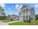 Street view of a row of new construction two-story homes, lawns, and sidewalks at 116 Midmills Ln, Summerville, SC 29486