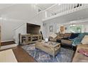 Cozy living room featuring hardwood floors, a large TV, and comfortable seating at 125 Crooked Creek Ct, Summerville, SC 29486