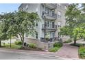 Exterior view of a condo building with charming balconies and lush landscaping at 125 Pier View St # 209, Charleston, SC 29492