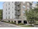 Multi-story condo building featuring balconies, brick accents, and well-maintained landscaping at 125 Pier View St # 209, Charleston, SC 29492