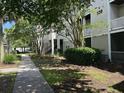 Exterior shot of the apartment building with green landscaping and a sidewalk at 1300 Park West Blvd # 519, Mount Pleasant, SC 29466