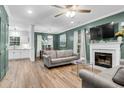 Spacious living room boasts wood floors, fireplace, and lots of natural light at 1328 Lark Ln, Hanahan, SC 29410