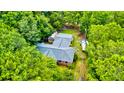 Home nestled among mature trees, with a greenhouse and RV parked on the property at 1384 Tibwin Rd, McClellanville, SC 29458