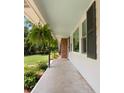 Covered porch detail with hanging ferns and black shutters providing a warm welcome at 1417 Downing St, Charleston, SC 29407