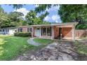 Charming brick home featuring a well-maintained lawn and a welcoming turquoise front door at 1520 Kirklees Abbey Dr, Charleston, SC 29407
