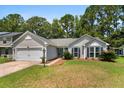 Single-story home featuring well-maintained landscaping and attached two-car garage at 170 Danzid Dr, Summerville, SC 29483