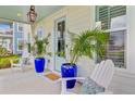 Inviting front porch with blue planters, cozy seating, and stylish decor at 176 Midtown Ave, Summerville, SC 29486