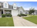 Inviting townhome with fresh green lawn and manicured bushes around the front at 192 Buchanan Cir, Goose Creek, SC 29445