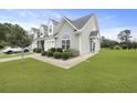 Well-maintained townhome featuring a lush green lawn and a neatly paved walkway at 192 Buchanan Cir, Goose Creek, SC 29445