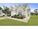 Beautifully maintained townhome, showcasing a well-manicured lawn and planted bushes at 192 Buchanan Cir, Goose Creek, SC 29445