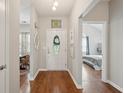 Inviting foyer with hardwood floors, neutral paint, and a view of the bedroom and dining area at 1975 Fruitwood Ave, Charleston, SC 29414