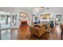 Cozy living room with hardwood floors, fireplace with red tile and French doors to another room at 1975 Fruitwood Ave, Charleston, SC 29414