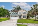 Inviting two-story home with manicured lawn, two-car garage and beautiful landscaping at 201 Old Market Ct, Moncks Corner, SC 29461