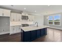 Bright kitchen featuring an island with quartz countertops, stainless steel appliances, and white cabinets at 2032 Sea Water Dr, Charleston, SC 29412